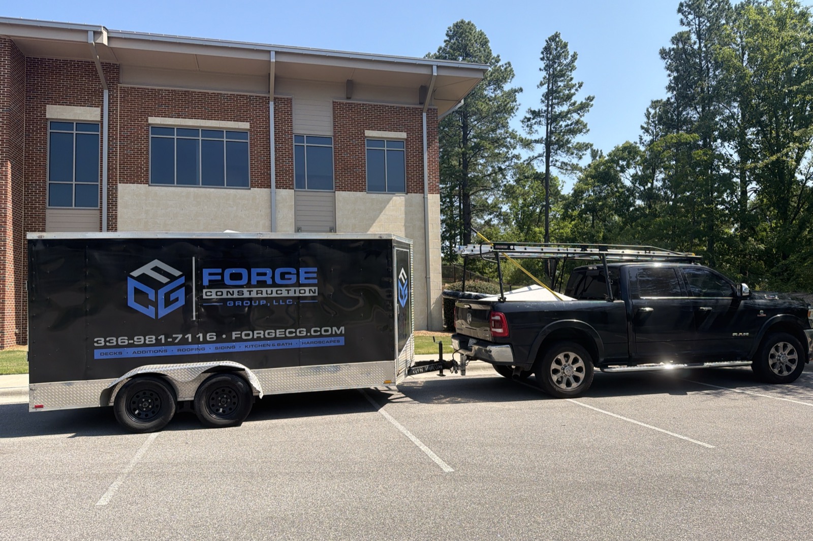 Forge Construction Group branded trailer and work truck