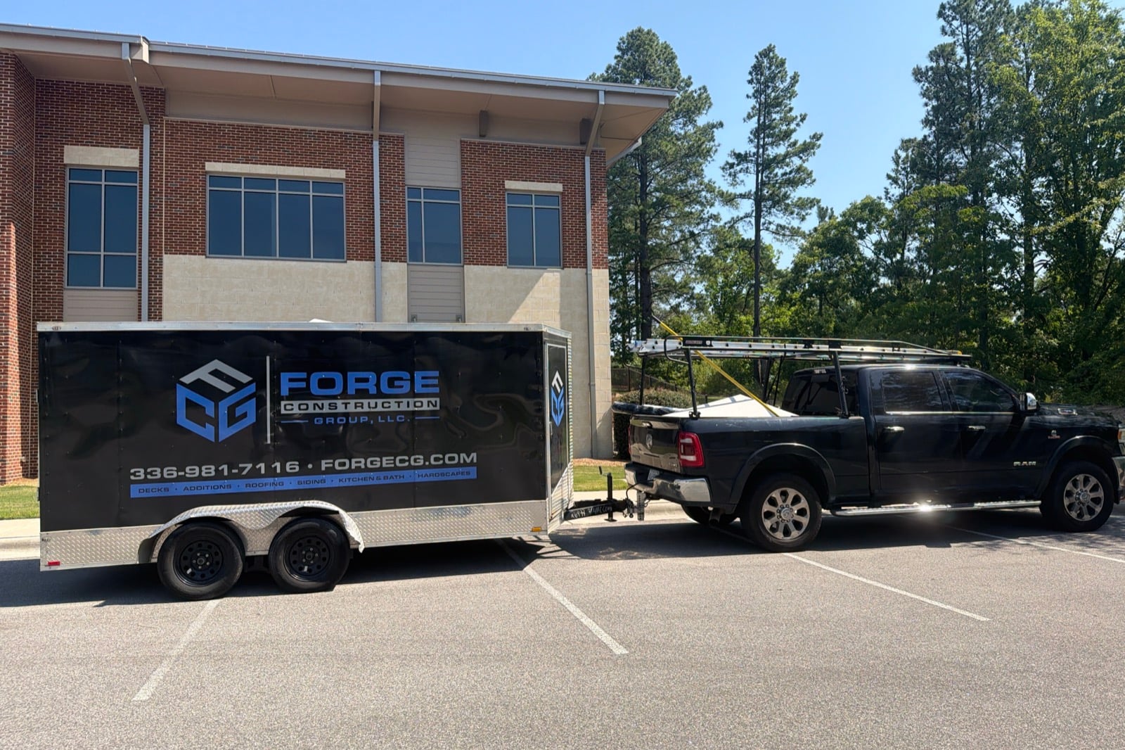 Forge Construction Group branded trailer and work truck
