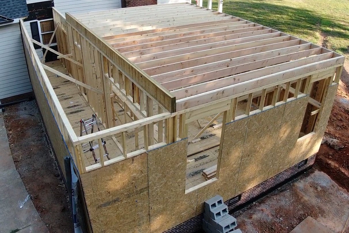 Aerial view of a home addition being framed by Forge Construction Group
