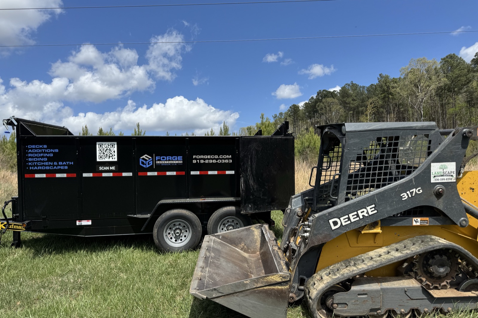 Forge Construction Group dumpster trailer and skid steer on a residential jobsite