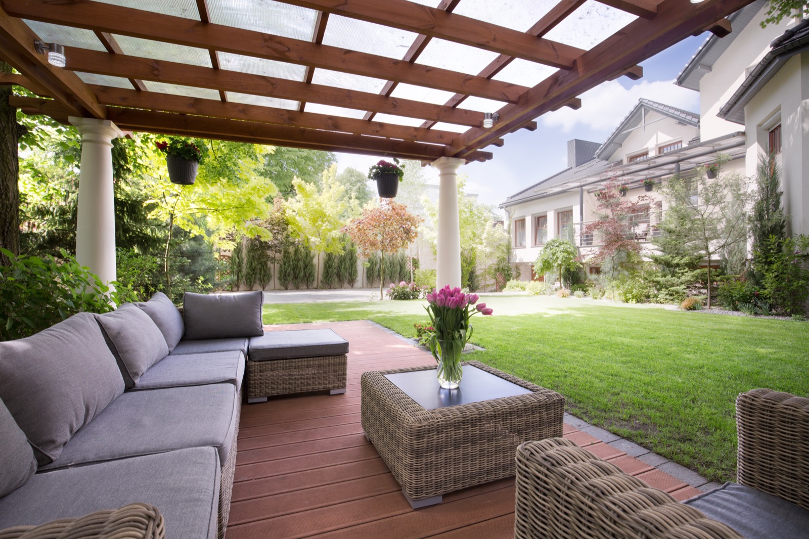Pergola over an outdoor lounge on a paver patio