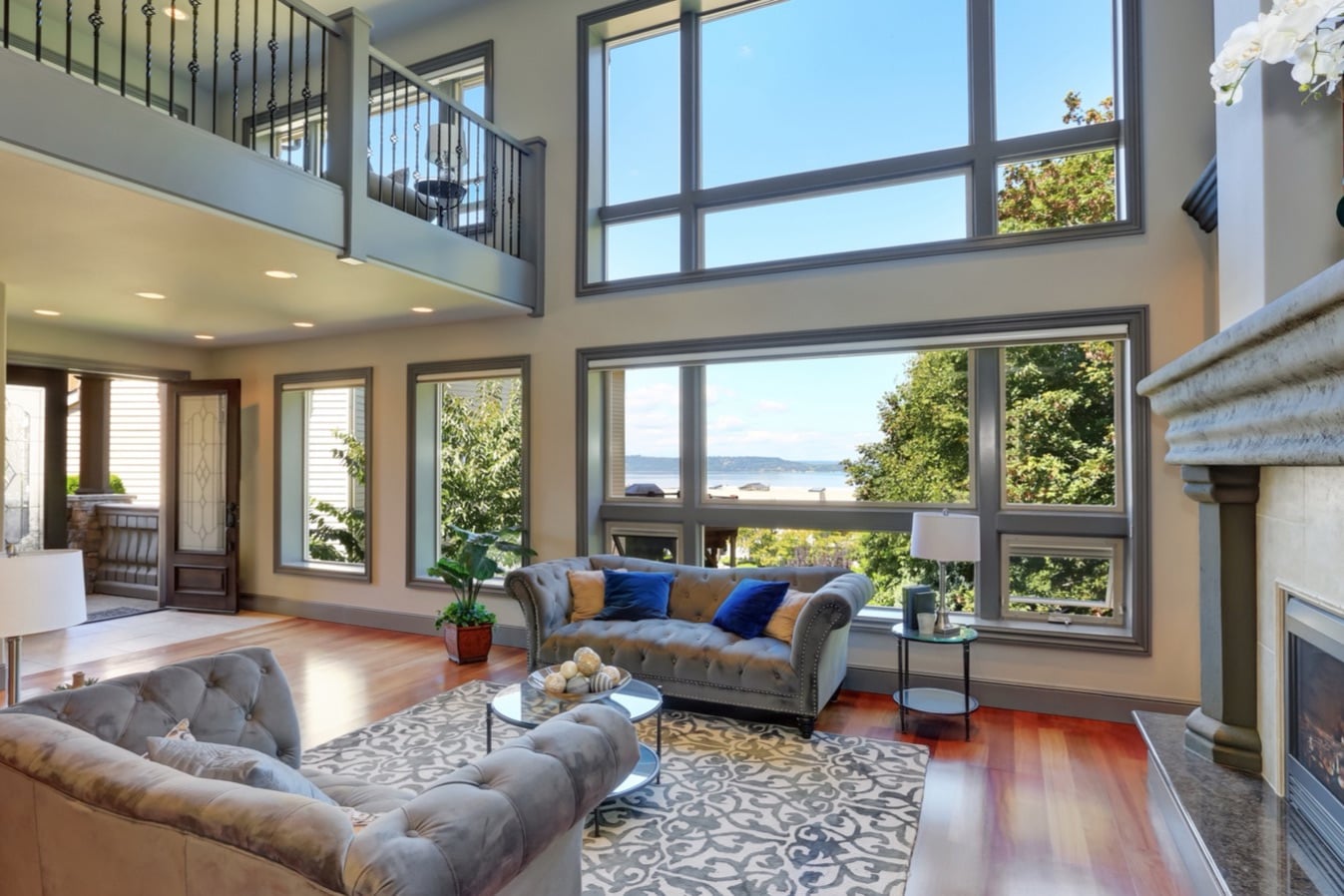 Two-story great room with tall windows and a fireplace